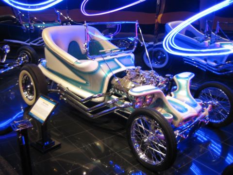 1968 Ford Mustang - Custom hot rod with exposed V8 engine and unique bodywork, displayed with blue neon lighting.