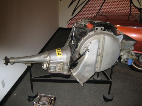 1968 Ford Mustang - Display of an automatic transmission and engine parts, likely in a museum setting.