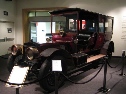 1968 Ford Mustang - This antique automobile is on display at a museum, a distinctive design with brass accents and a covered passenger compartment.