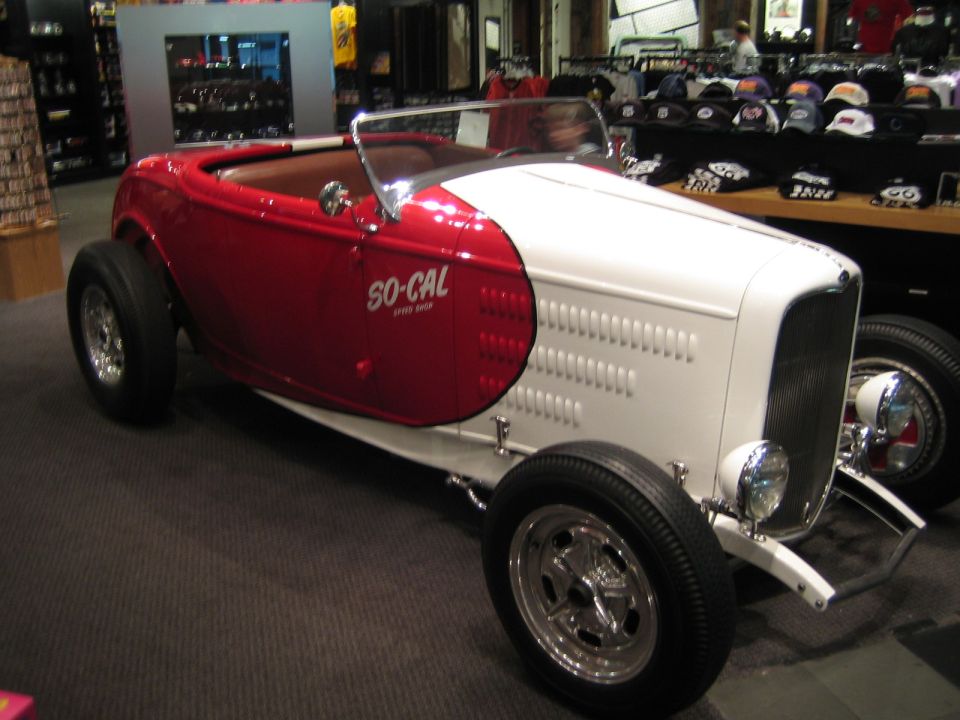 Red and white hot rod with "SO-CAL SPEED SHOP" text on the side, viewed from a 3/4 front angle