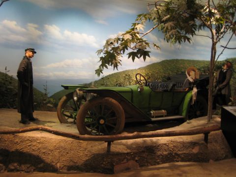 1968 Ford Mustang - A diorama depicts a vintage touring car with two mannequins in a scenic, mountainous setting.