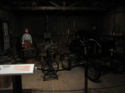 1968 Ford Mustang - A historical scene depicts a vintage automobile alongside a blacksmith's tools and a mannequin.