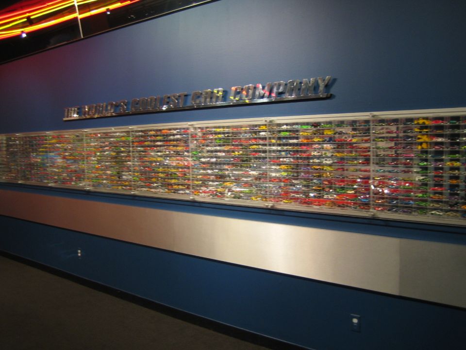 Wall display case filled with hundreds of colorful model cars