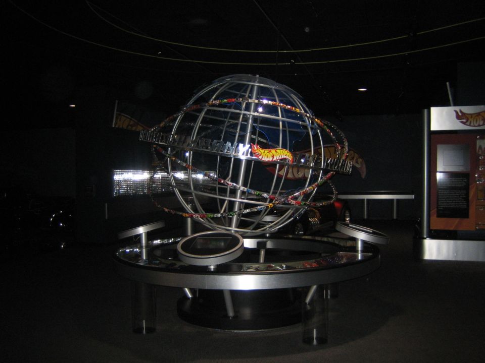 Hot Wheels World logo globe with Hot Wheels cars on display