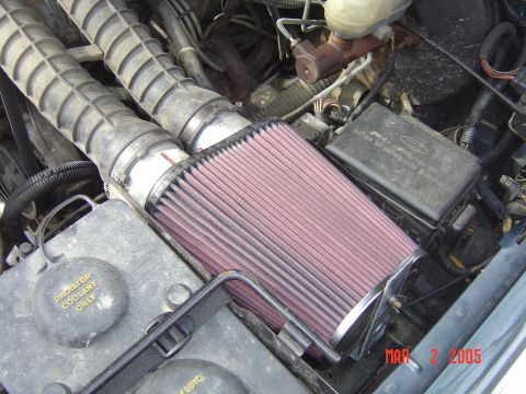 1993 Ford Bronco - Close-up of an engine bay showing a K&N air filter assembly with dual intake hoses and a "Radiator Coolant Only" cap.
