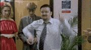 1995 Ford Bronco - A man dances enthusiastically in an office setting, with two other individuals observing.