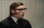 1995 Ford Bronco - A man in a suit and glasses speaks animatedly, his face captured in a close-up shot.