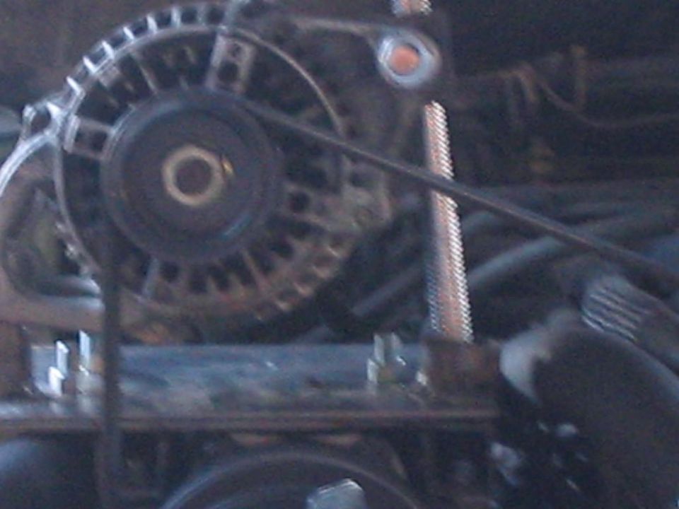 Close-up of a vehicle's alternator and belt system