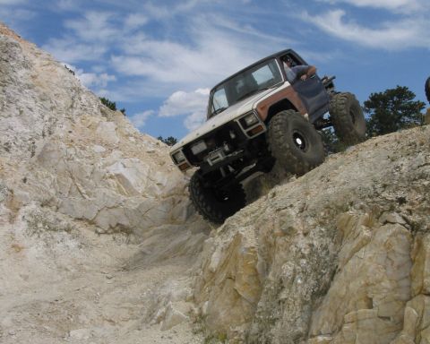 1981 Ford Bronco - Modified 1981 Ford Bronco tackling a challenging off-road trail.