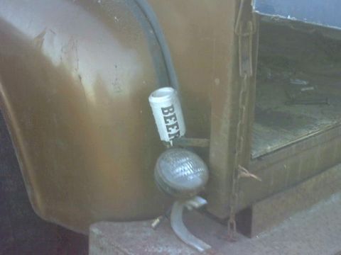 1972 Ford F-100 - A beer can is attached to the taillight of a vintage truck, suggesting a custom modification.