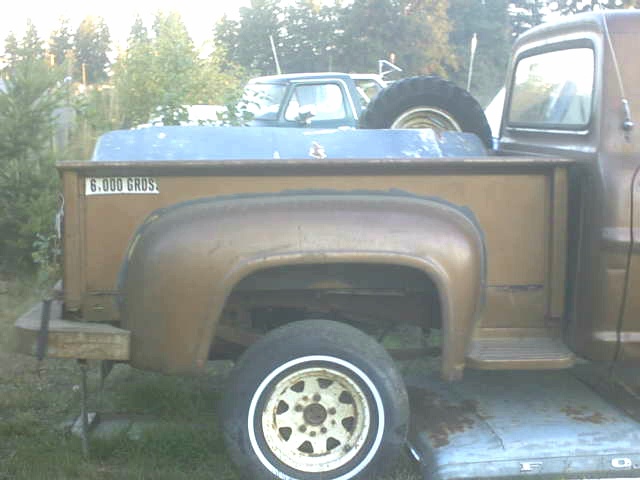1972 Ford F-100 pickup truck, brown, with another truck behind it