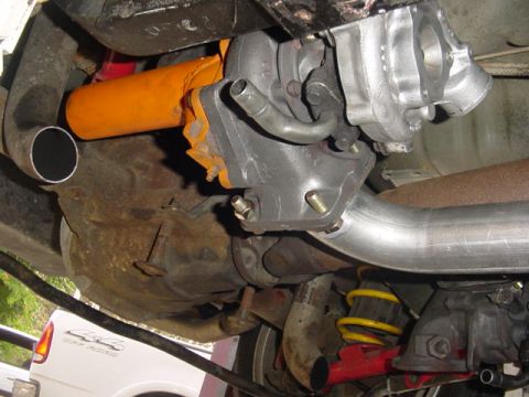 1995 Ford Mustang - Underside view of a vehicle's turbocharger and exhaust system, with suspension components also visible.