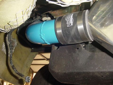 1995 Ford Mustang - Close-up of a blue intake pipe connected with a clamp the SIH logo, likely part of an engine modification.