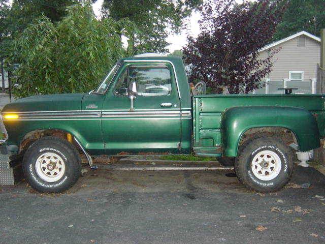 Green pickup truck, side view. BFGoodrich Radial All-Terrain T/A tires