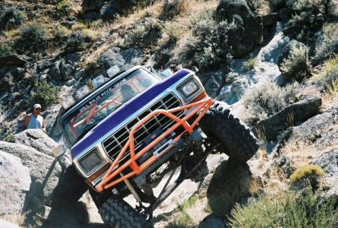1979 Ford Bronco - This modified 1979 Ford Bronco navigates a rocky trail with its custom roll cage and large tires.