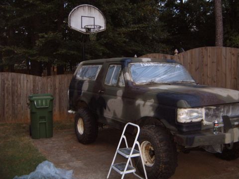 1988 Ford Bronco - A Ford Bronco is being prepped for a camouflage paint job in a backyard setting.