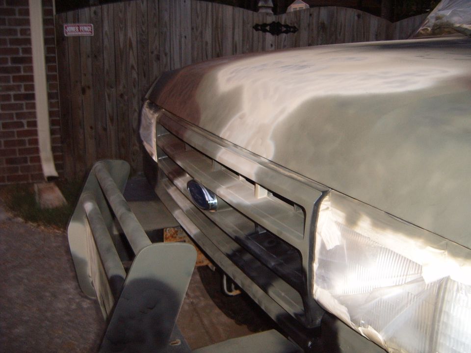 Front grille and hood of a vehicle undergoing paint work