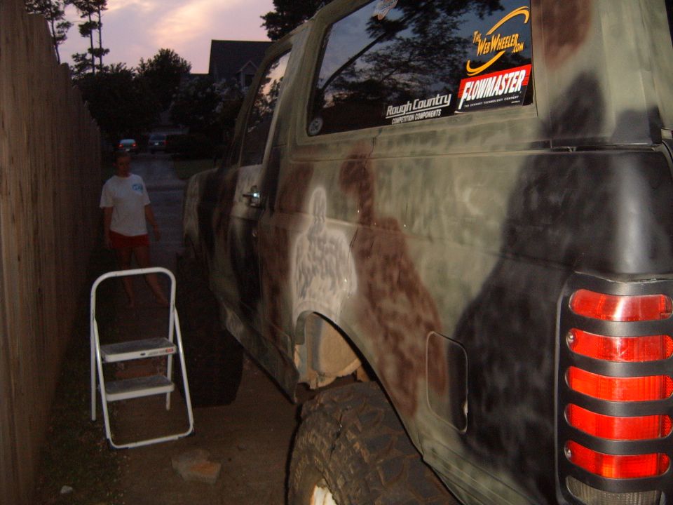 Camouflaged SUV side view with Rough Country and Flowmaster stickers