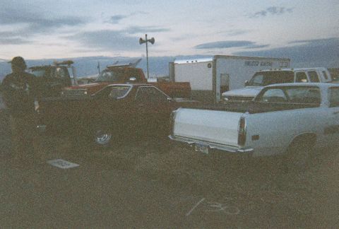 1972 Ford Ranchero - Two Ford Rancheros and other vehicles are parked at an outdoor event during dusk.