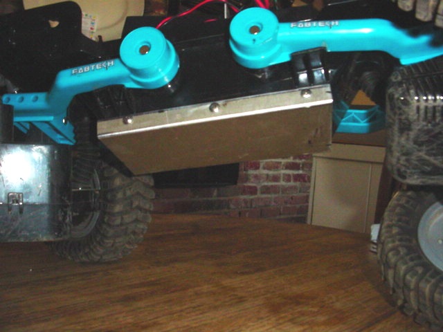 RC crawler chassis with blue Fabtech suspension parts and large tires