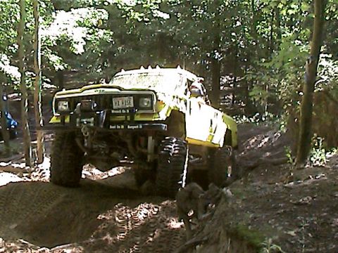 1977 Ford F-150 - Modified Jeep Cherokee XJ tackles a challenging off-road trail in the woods.