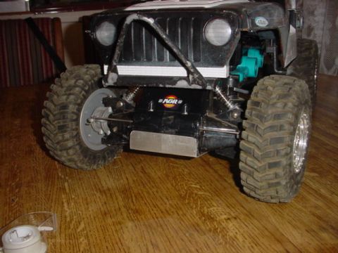 1988 Ford Bronco - This RC crawler vehicle has a appearance with oversized tires and a visible suspension system.
