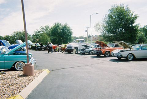 1972 Ford Ranchero - A variety of vintage vehicles are displayed at an outdoor car show under a partly cloudy sky.