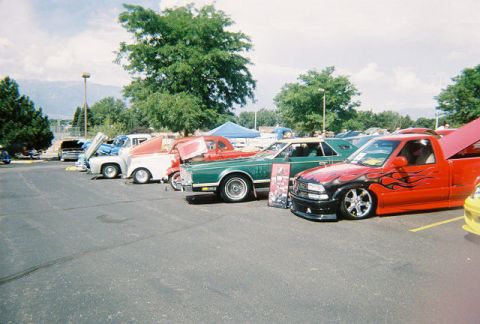 1972 Ford Ranchero - A variety of vehicles are displayed at an outdoor event under a cloudy sky.