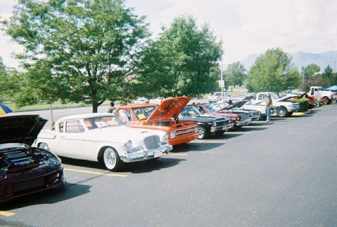 1972 Ford Ranchero - A variety of vintage automobiles are displayed at an outdoor car show under a partly cloudy sky.