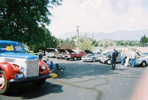 1972 Ford Ranchero - A variety of vintage vehicles are displayed at an outdoor event under a partly cloudy sky.
