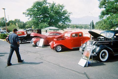 1972 Ford Ranchero - A car show features multiple vintage vehicles on display under a bright sky.