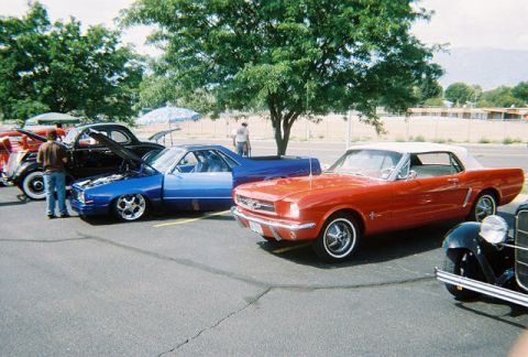 1972 Ford Ranchero - A variety of classic cars are on display at an outdoor event under a large tree.