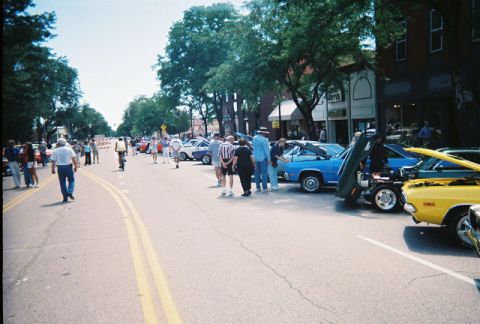 1972 Ford Ranchero - Cars are displayed on a street during a car show event.
