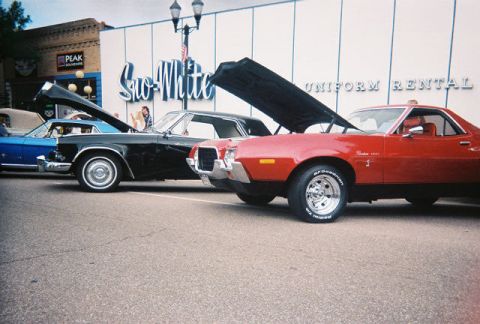 1972 Ford Ranchero - A red 1972 Ford Ranchero is parked with its hood open at a car show.