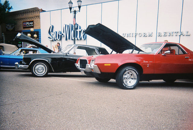 Red 1972 Ford Ranchero with hood open, parked on asphalt