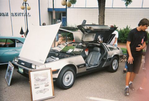 1972 Ford Ranchero - DeLorean DMC-12 on display at a car show, hood and doors open.