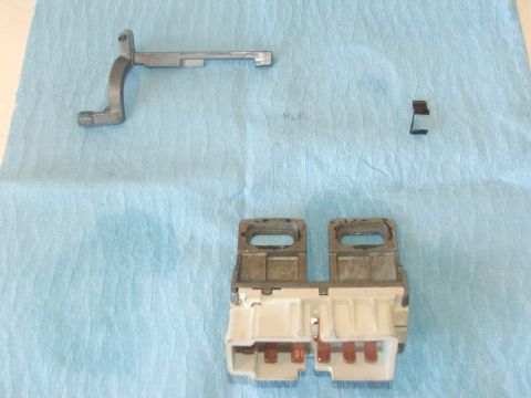 1989 Ford Bronco - Ignition switch and linkage components laid out on a blue cloth.
