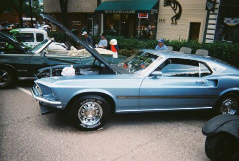 1972 Ford Ranchero - A light blue 1969 Ford Mustang Mach 1 is displayed with its hood open at a car show.