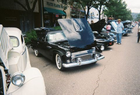 1972 Ford Ranchero - A black 1957 Ford Thunderbird convertible is displayed with its hood open at a car show.