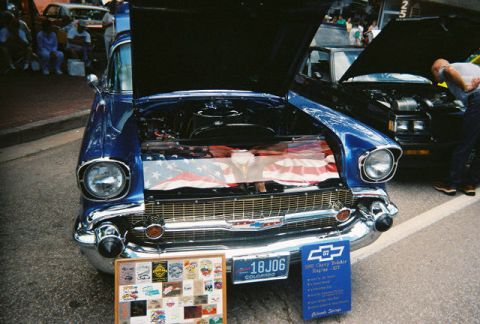 1972 Ford Ranchero - Front view of a blue 1957 Chevrolet Bel Air at a car show, with another car behind it.