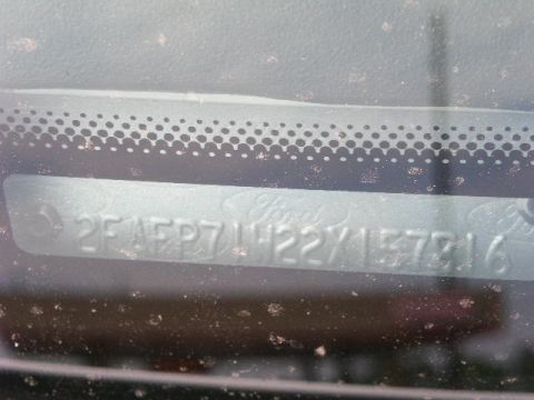 2001 Ford Crown Victoria - The vehicle identification number (VIN) is visible on a metal plate affixed to the car's dashboard.