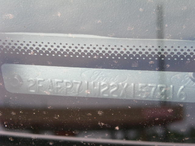 Close-up of a car's VIN plate on the windshield. It reads 2F4FP71H22Y157716