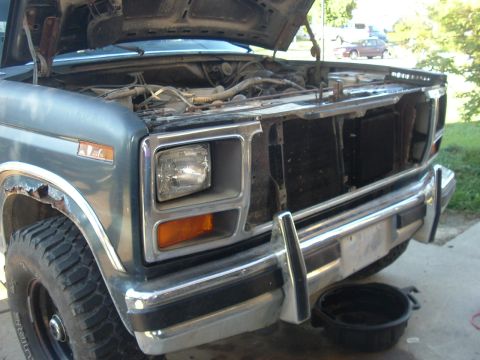 1982 Ford Bronco - Front view of a 1980 Ford Bronco with the hood up, revealing the engine compartment.