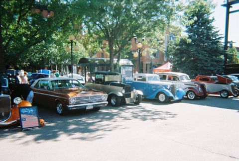 1972 Ford Ranchero - A row of classic cars are on display at an outdoor event.