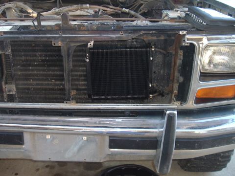1982 Ford Bronco - Aftermarket transmission cooler mounted in front of the radiator on a vehicle's front end.