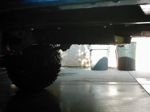 1978 Ford Bronco - Close-up view of a vehicle's undercarriage, focusing on the suspension and a large tire. The Supermotors.net logo is present in the lower r…
