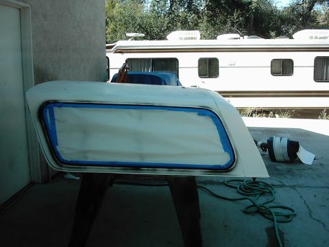 1978 Ford Bronco - A vehicle door panel is prepped with masking tape for painting, with an RV visible in the background.