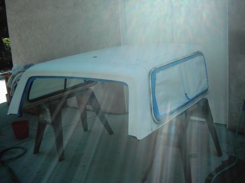 1978 Ford Bronco - A vehicle hardtop is prepped for painting, supported by sawhorses in an indoor setting.