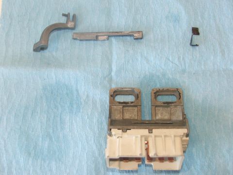 1989 Ford Bronco - Disassembled ignition switch components laid out on a blue cloth, with a Supermotors.net watermark visible.
