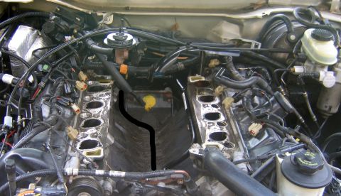 2000 Ford Crown Victoria - Engine bay with intake manifold removed, revealing internal components and wiring.
